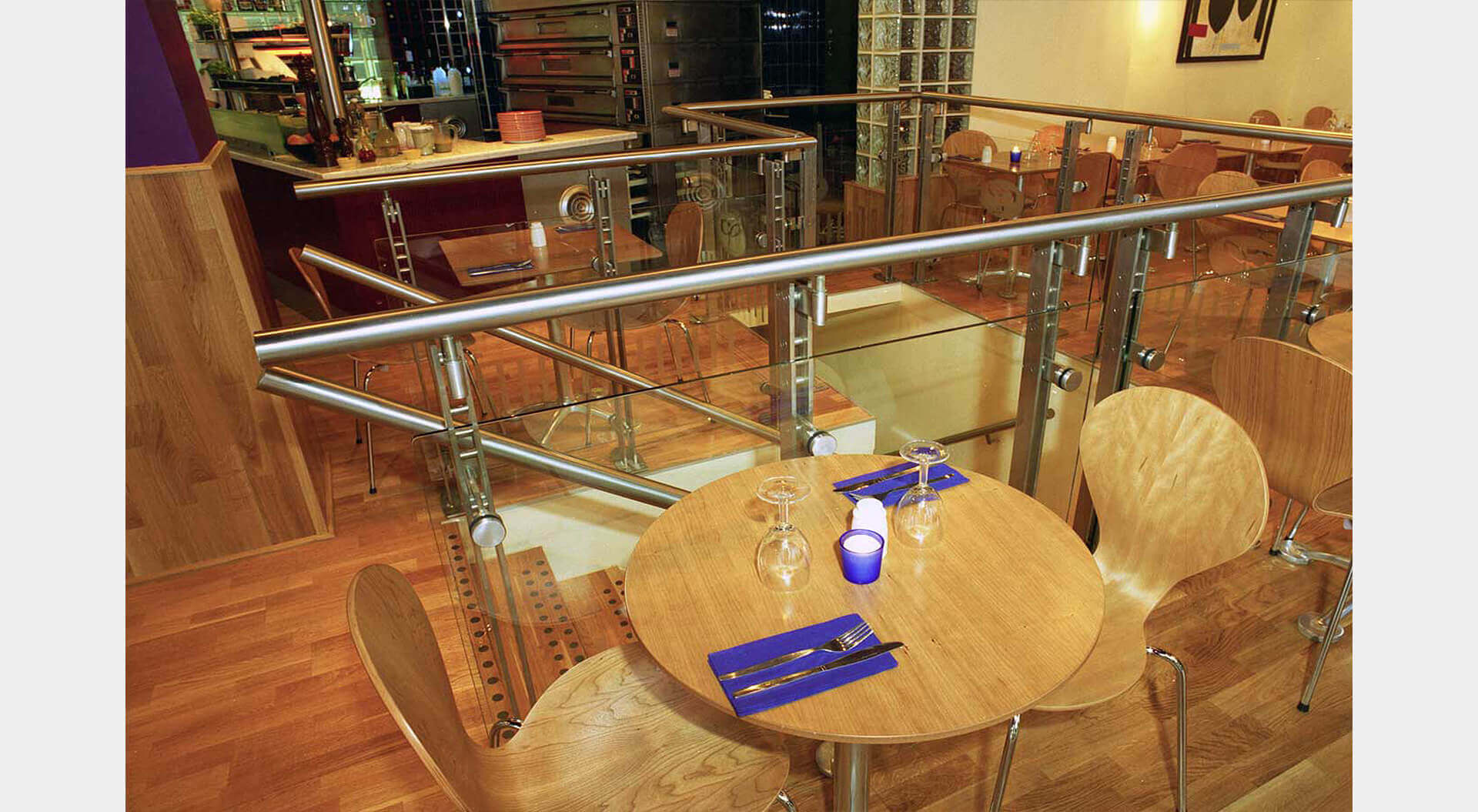 Caffe Piazza restaurant table and seating next to staircase design 